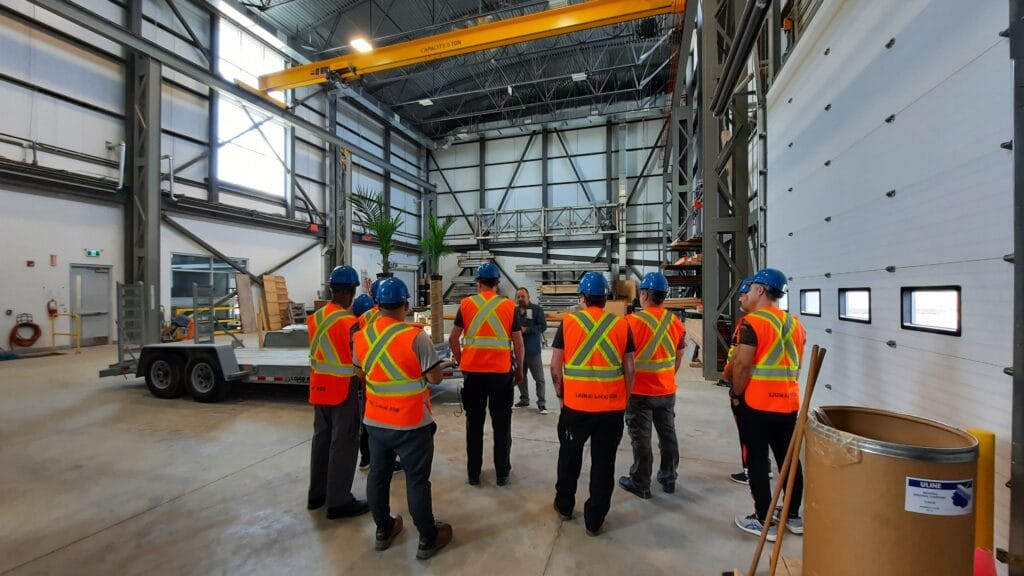 Construct's participants gathering in a warehouse